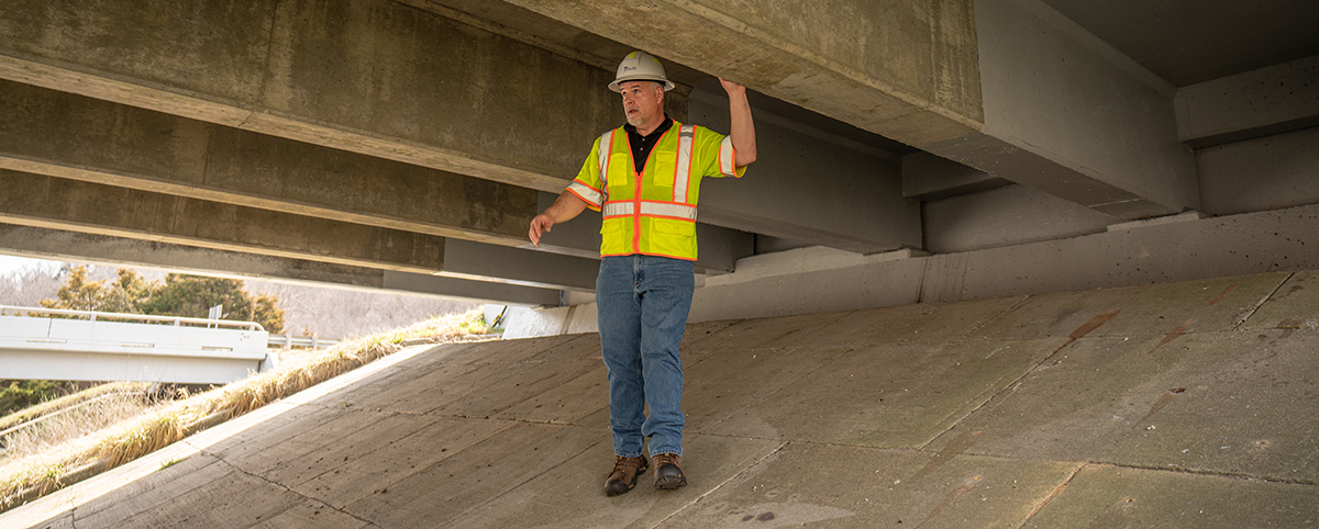 Pillar Worker Underneath Bridge