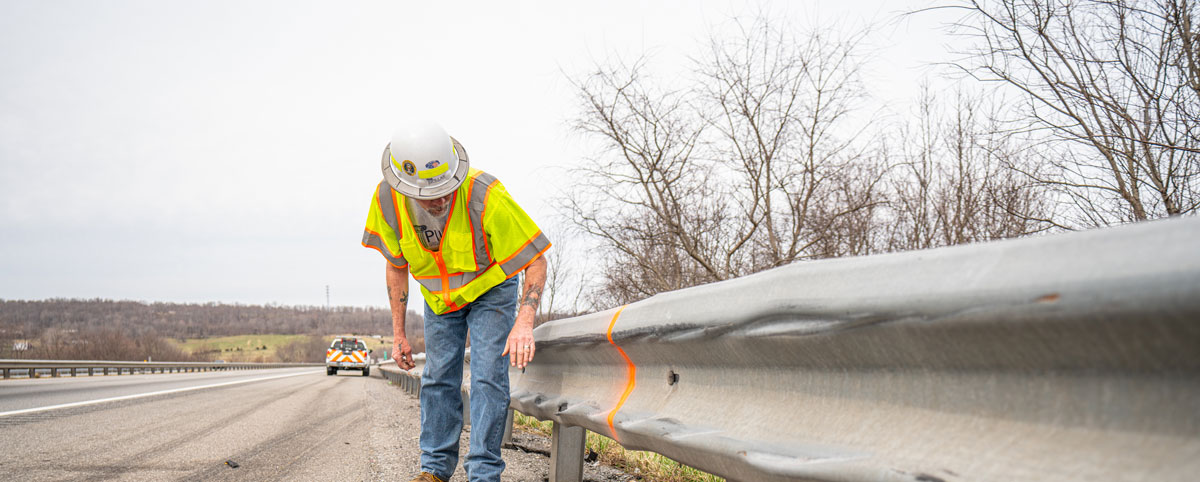 PILLAR Employee Inspecting Guardrail