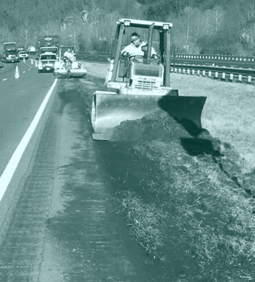 Dozer Plowing Dirt on Shoulder of Highway