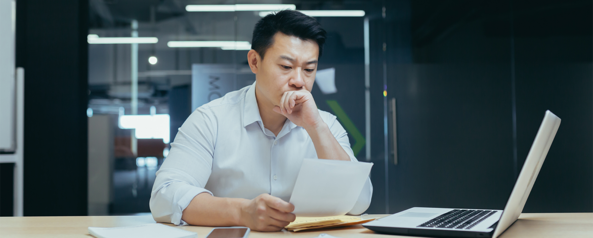 Man frustrated while reading over a request for proposal (RFP)